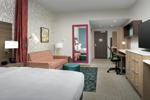 a hotel room with a bed and a desk at Home2 Suites By Hilton Weston Ft. Lauderdale in Davie