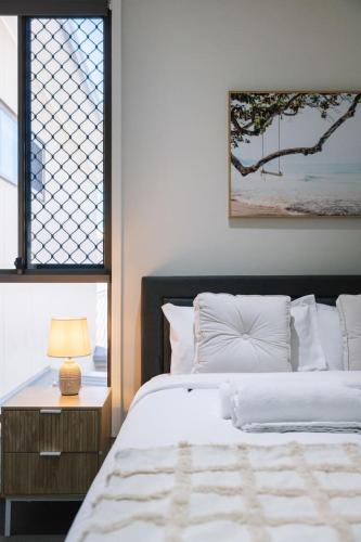 a bedroom with a bed and a table with a lamp at Modern Comfort Patio and Workstation with Garage in North Lakes
