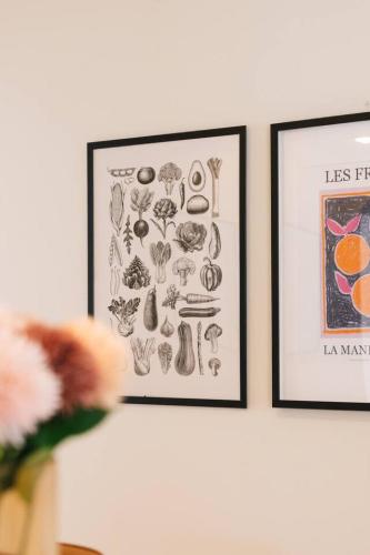 two framed pictures of vegetables on a wall at Spacious 4BR Family Home in Capalaba Local Charm in Capalaba