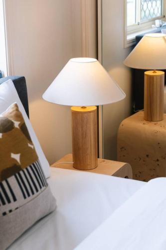 a lamp sitting on a table next to a bed at Spacious 4BR Family Home in Capalaba Local Charm in Capalaba
