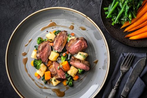 a plate of food with meat and vegetables on a table at The Daffodil Hotel & Spa in Grasmere