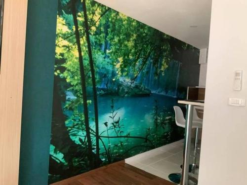 a mural of a forest on a wall in a room at LES CLEFS DU PARADIS avec SPA in Montferrand-le-Château
