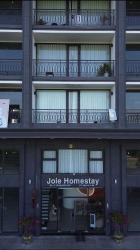 a building with a jute homesteadery sign on it at Joie Homestay Huế in Thôn Trường Giang