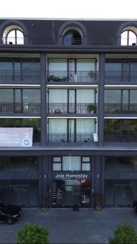 a large building with a jk hamneys sign on it at Joie Homestay Huế in Thôn Trường Giang