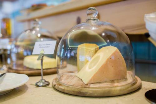 a glass jar with cheese in it on a counter at Hotel AlpenSchlössl in Sankt Johann im Pongau