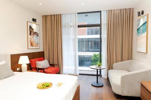 ein Hotelzimmer mit einem Bett, einem Stuhl und einem Fenster in der Unterkunft MYAN Villa Phòng nghỉ 3 Vinhomes Ocean Park 3 in Ðình Loan