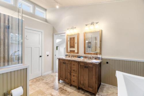 a bathroom with two sinks and a mirror at Woodland Hollow in Minnetonka