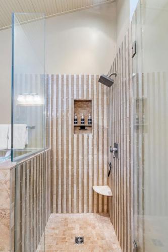 a bathroom with a shower with a glass door at Woodland Hollow in Minnetonka