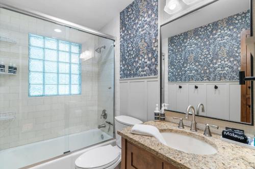 a bathroom with a sink and a toilet and a tub at Woodland Hollow in Minnetonka