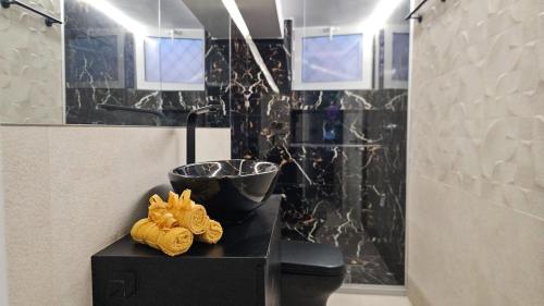 a bathroom with a shower with two towels on a table at Casa Katerini Bright 3BR with Balcony in Chania Town