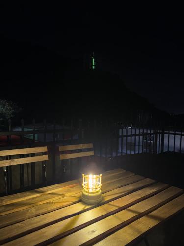 a candle sitting on a wooden table at night at Xiao Houyuan in Yuanshan