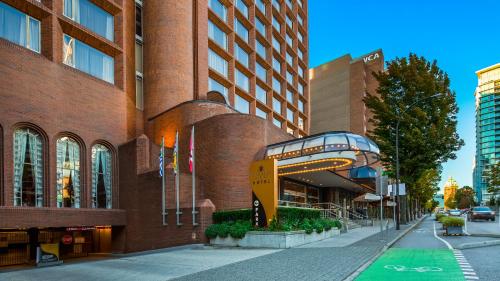 a building on a street next to a building at Georgian Court Hotel, WorldHotels Elite in Vancouver