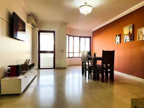 a dining room with a table and chairs at Amazing Appartement au centre ville en face HILTON & la Gare Train de TGV in Tangier
