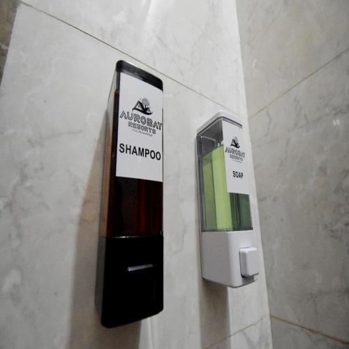 a cell phone on a wall with a sign on it at Aurobay Resorts Pondicherry in Auroville