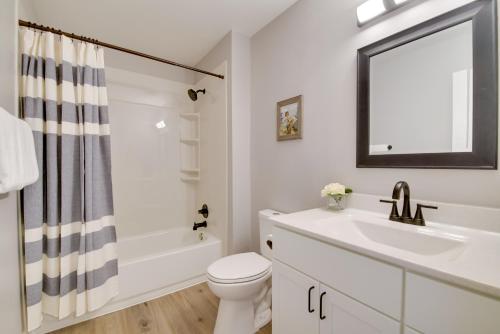 a bathroom with a sink and a toilet and a mirror at Kimberling City Getaway Fish and Boat Nearby! in Kimberling City