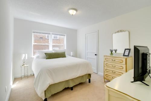 a bedroom with a bed and a desk with a tv at Walk to Ritter Park Renovated Home Near Marshall! in Huntington