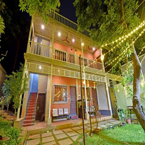 a house with christmas lights in front of it at Aurobay Resorts Pondicherry in Auroville