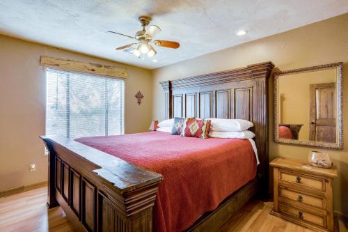een slaapkamer met een groot bed en een plafondventilator bij Mtn-View Adobe Home with Large Deck Near Prescott! in Humboldt
