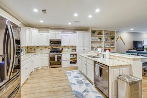 a kitchen with white cabinets and a counter top at Tranquil Views Riverfront Retreat in Hot Springs! in Hawes