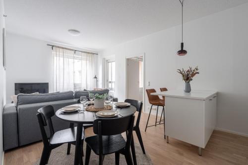 a living room with a table and a couch at "Ketlari"- Homelike 1BR Apartment with Sauna in Historic Area, Hosted by 2ndhomes in Tampere
