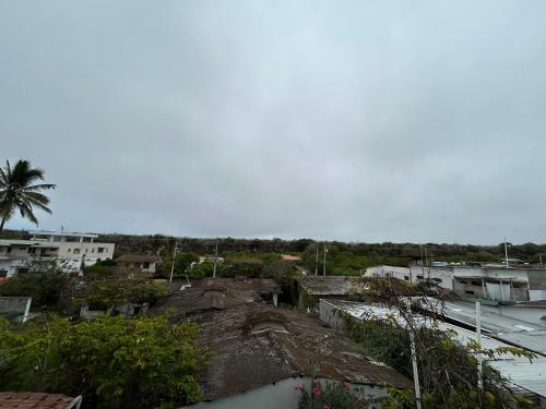 a view of a city with buildings and trees at Hostal Sir Francis Drake in Puerto Ayora