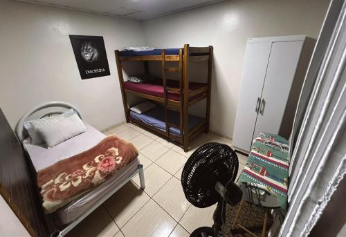 a small room with a small bed and a closet at Pousada Locks, Cascavel, Paraná - 02 in Cascavel