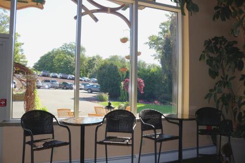 a patio with a table and chairs and a window at The Lodge at Woodstone Country Club in Danielsville