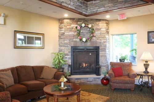 a living room with a couch and a fireplace at The Lodge at Woodstone Country Club in Danielsville