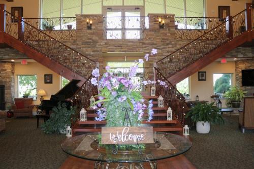a vase of flowers on a table in a lobby at The Lodge at Woodstone Country Club in Danielsville