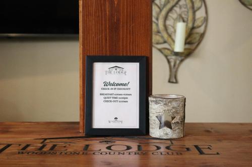 a candle and a frame on a table at The Lodge at Woodstone Country Club in Danielsville