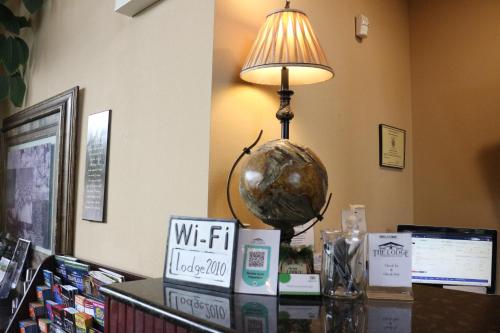 a lamp on a table with a globe on it at The Lodge at Woodstone Country Club in Danielsville