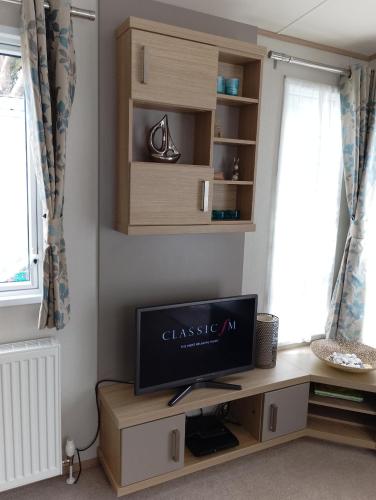 a tv sitting on a desk in a room at Roxbury 5 Star 6 berth Luxury Caravan in Exeter