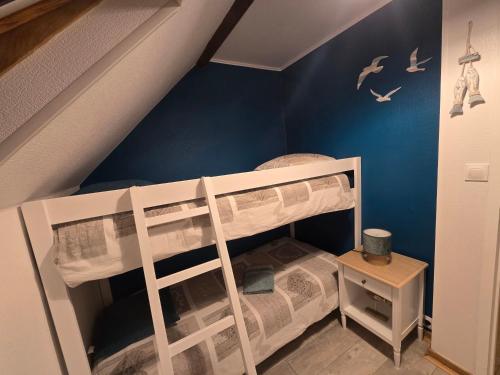 a bedroom with two bunk beds in a attic at Douceur du D-Day sites historiques du Débarquement in Englesqueville-la-Percée