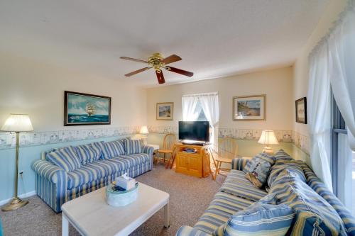 a living room with two couches and a tv at Spacious Kill Devil Hills Getaway with 3 Decks! in Kill Devil Hills