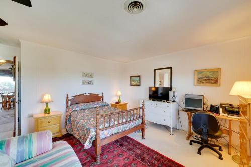 a bedroom with a bed and a desk with a computer at Spacious Kill Devil Hills Getaway with 3 Decks! in Kill Devil Hills
