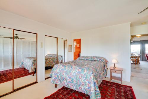 a bedroom with two beds and a mirror at Spacious Kill Devil Hills Getaway with 3 Decks! in Kill Devil Hills