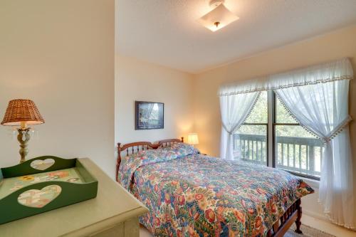 a bedroom with a bed and a window at Spacious Kill Devil Hills Getaway with 3 Decks! in Kill Devil Hills