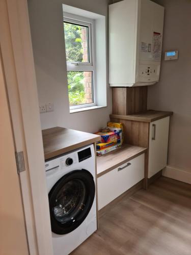 a laundry room with a washer and dryer in it at Modern 2 bedroom Apartment with River views in Behy Bridge