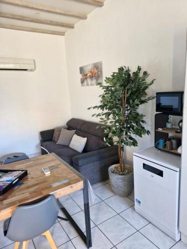 a living room with a couch and a table at le Rempart in Grignan