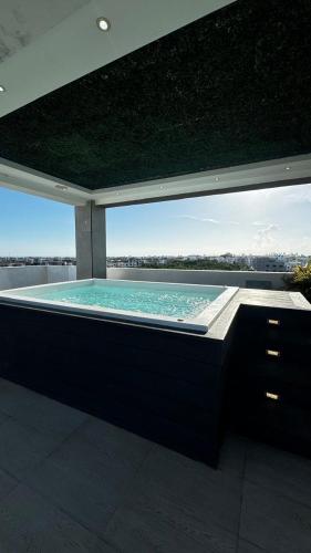 a large swimming pool with a view of the city at Apartmet luxury monaco in Juan López