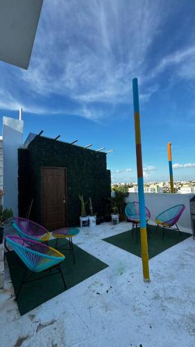 a group of chairs and tables on a patio at Apartmet luxury monaco in Juan López