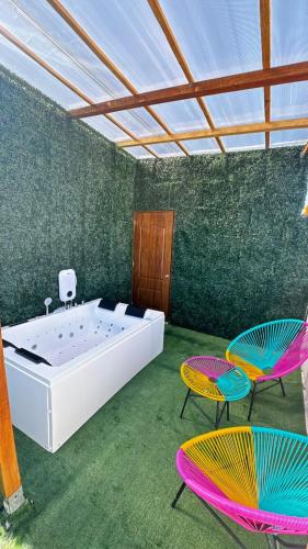 a large room with a tub and two chairs at Apartmet luxury monaco in Juan López