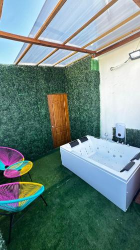 a bathroom with a tub and a table and a chair at Apartmet luxury monaco in Juan López
