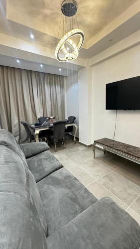 a living room with a couch and a flat screen tv at Apartmet luxury monaco in Juan López