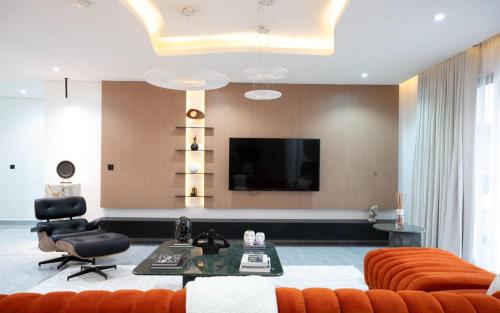 a living room with a couch and a flat screen tv at Stunning 3 bedroom apartment ikoyi in Ikoyi