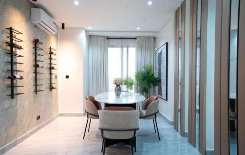 a dining room with a table and chairs at Stunning 3 bedroom apartment ikoyi in Ikoyi