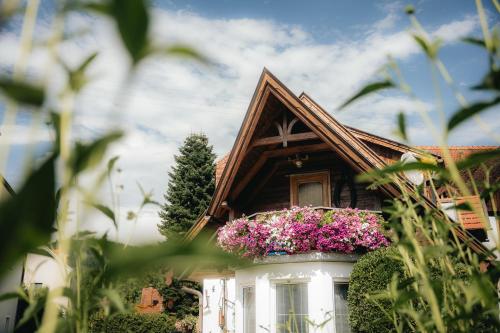 a house with flowers in a window box at Schmiedbauerhof in Sankt Margarethen im Lavanttal