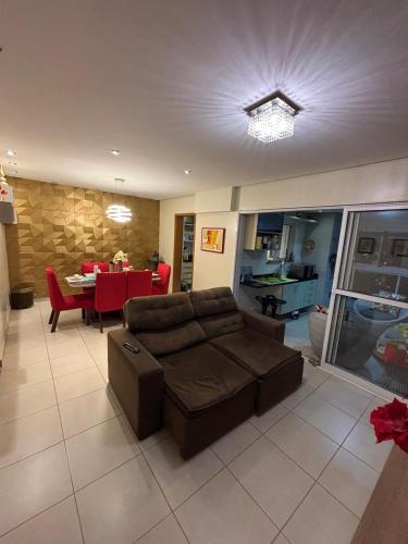 a living room with a couch and a dining room at TORRE SOLAZZO - Cop 30 in Belém
