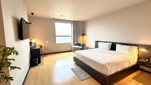 a hotel room with a bed and a window at Tequendama Hotel Medellín - Estadio in Medellín