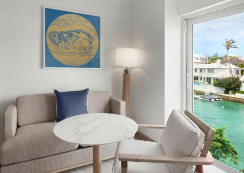 a living room with a couch and a table and a window at Hamilton Princess & Beach Club A Fairmont Managed Hotel in Hamilton